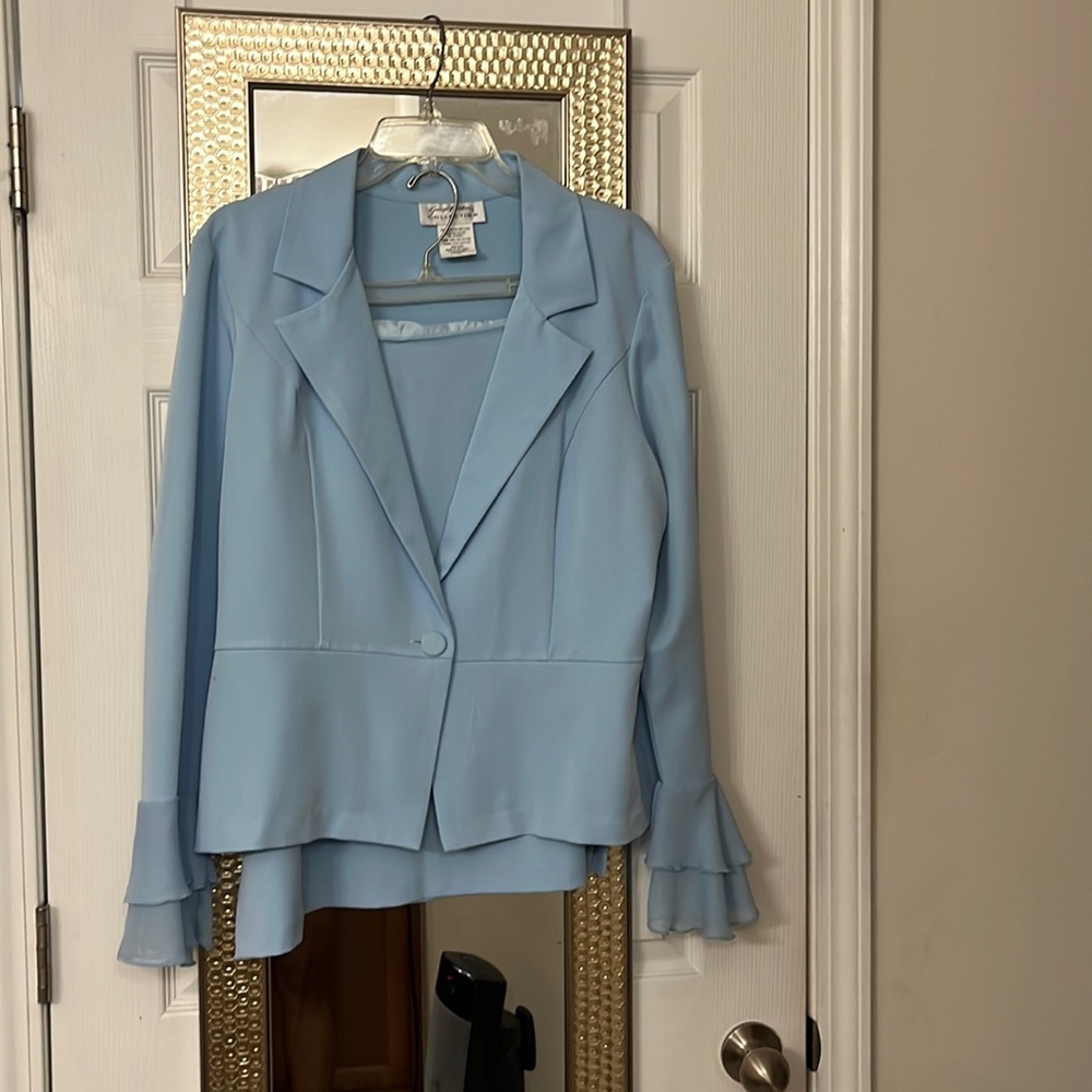 2 piece skirt & jacket w/1 button.  2 layers of ruffles @ And of sleeves.